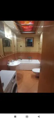 a bathroom with two sinks and a bath tub at Zora in Niš