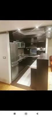 a large kitchen with stainless steel appliances in it at Zora in Niš