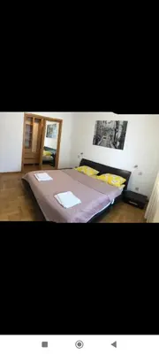 a bedroom with a large bed with two towels on it at Zora in Niš