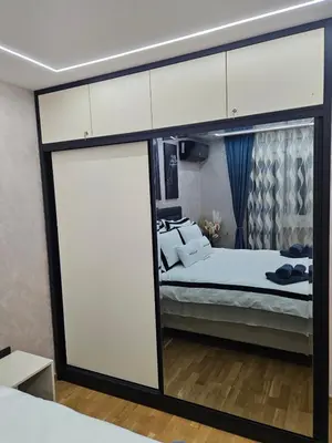 a room with a bed and a large sliding glass door at POSEJDON DELUXe 3 in Vrnjačka Banja