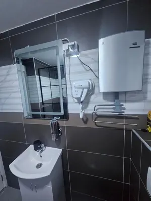 a bathroom with a sink and a mirror on the wall at POSEJDON DELUXe 3 in Vrnjačka Banja