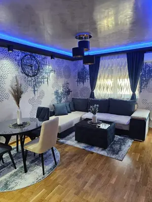 a living room with a couch and a table at POSEJDON DELUXe 3 in Vrnjačka Banja