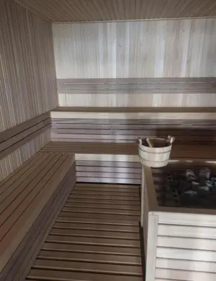 an empty sauna with a basket in the middle at Una LUX N85 in Kopaonik