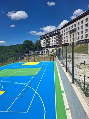 a basketball court in front of a building at Una LUX N85 in Kopaonik