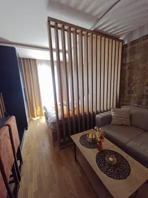 a living room with a couch and a table at Una LUX N85 in Kopaonik