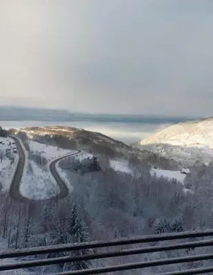 a snow covered hill with a road on it at Una LUX N85 in Kopaonik