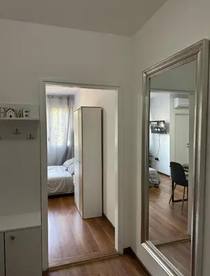 a mirror in a room with a bedroom and a bed at Stan na dan Raška in Raška