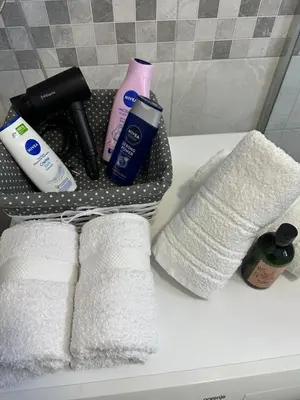 a rack with towels and other bathroom items on a sink at Stan na dan Raška in Raška