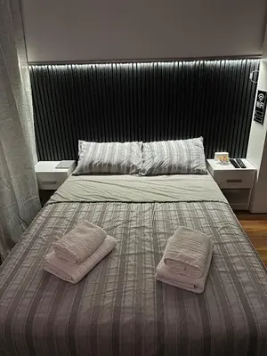 a bedroom with a bed with two towels on it at Stan na dan Raška in Raška
