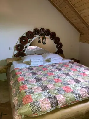 a bedroom with a bed with a wooden head board at Semeteška bajka in Raška