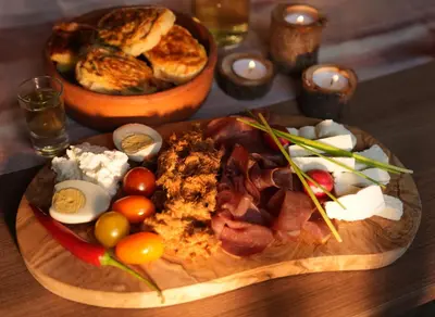 a plate of food on a wooden table at Mladenović Kuća in Kopaonik