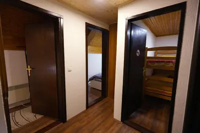 a hallway with two doors and a room with a bunk bed at Mladenović Kuća in Kopaonik