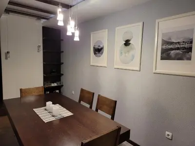 a dining room with a wooden table and chairs at Zoi i Nika Kopaonik in Kopaonik