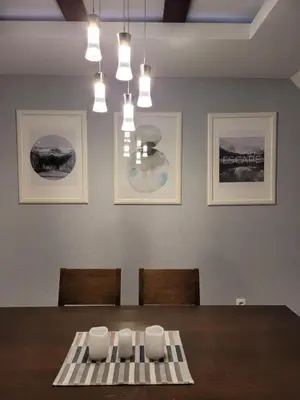 a dining room with a table with chairs and pictures at Zoi i Nika Kopaonik in Kopaonik