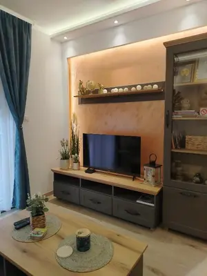a living room with a flat screen tv at Apartman Amber Vrnjačka Banja in Vrnjci