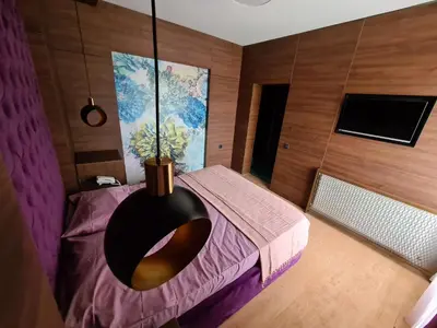 a room with a bed with a vase on it at Hotel Zeleni Vir in Niš