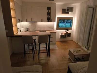 a kitchen with a table and chairs in a room at Apartman Vujanac in Vrnjačka Banja