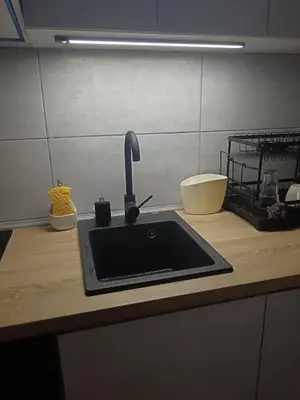 a kitchen counter with a sink and a faucet at Udoban kutak 2 in Niš