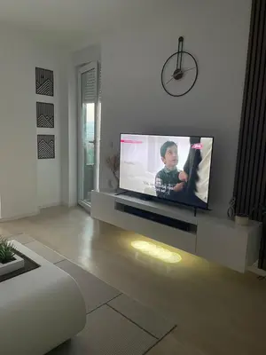 a living room with a large flat screen tv at Udoban kutak 2 in Niš