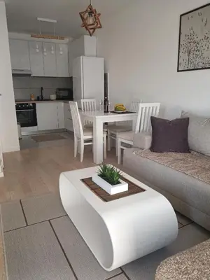 a living room with a couch and a table at Udoban kutak 2 in Niš