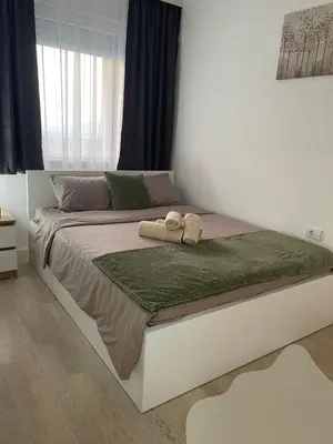 a bed with two towels on it in a bedroom at Udoban kutak 2 in Niš