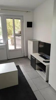 a room with a kitchen with a desk and a window at Smeštaj Golubica 1 in Soko Banja