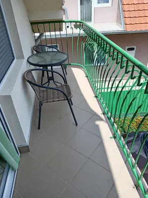 a balcony with a table and a chair on it at Smeštaj Golubica 3 in Soko Banja