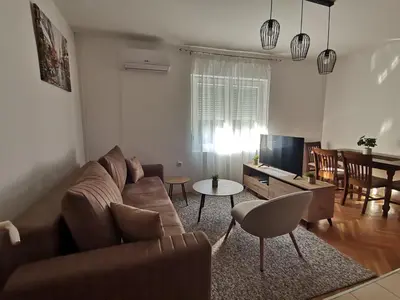 a living room with a couch and a table at Apartman Pače in Raška