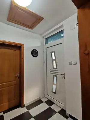a door in a room with a checkered floor at Apartman Pače in Raška