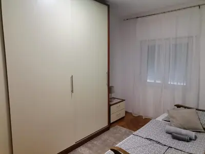 a bedroom with a large mirror next to a bed at Apartman Pače in Raška