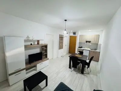a kitchen and dining room with a table and chairs at Aqua Apartments 3 in Jagodina