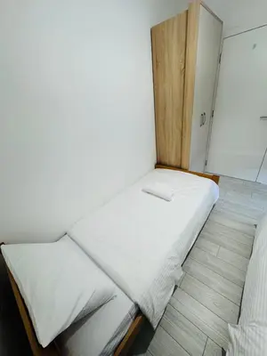 a small room with two beds in it at Aqua Apartments 3 in Jagodina