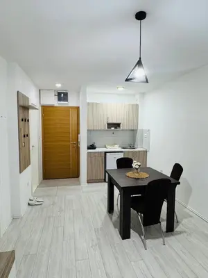 a kitchen and dining room with a table and chairs at Aqua Apartments 3 in Jagodina