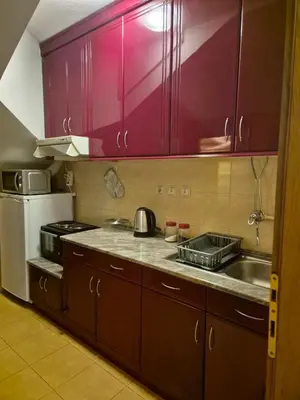 a kitchen with purple cabinets and a sink and a refrigerator at Toplica in Vrnjačka Banja