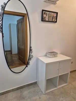 a mirror on a wall next to a white dresser at Toplica in Vrnjačka Banja