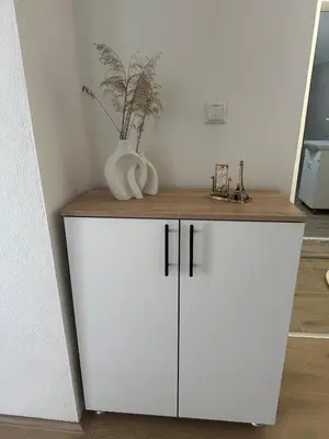 a white cabinet with a vase on top of it at Daily corner in Bujanovac