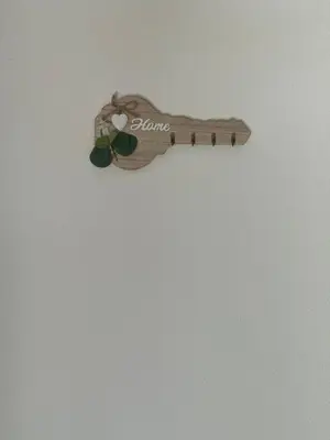 a wooden guitar hanging on a white wall at Daily corner in Bujanovac