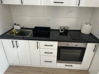 a small kitchen with a sink and a stove at Daily corner in Bujanovac