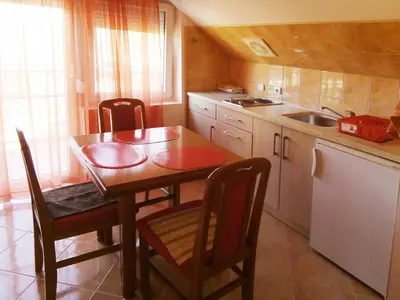 a kitchen with a table and chairs and a sink at Sokograd in Soko Banja