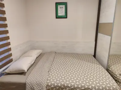 a small bedroom with a bed and two pillows at Apartman Stefan Vrnjacka Banja in Vrnjačka Banja