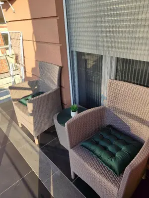 a porch with two chairs and a table on a balcony at Apartman Stefan Vrnjacka Banja in Vrnjačka Banja