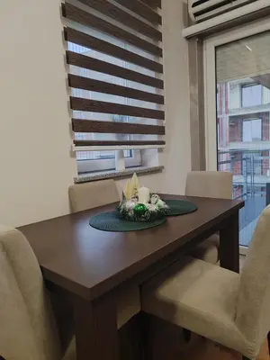 a dining room table with a plate of food on it at Apartman Stefan Vrnjacka Banja in Vrnjačka Banja