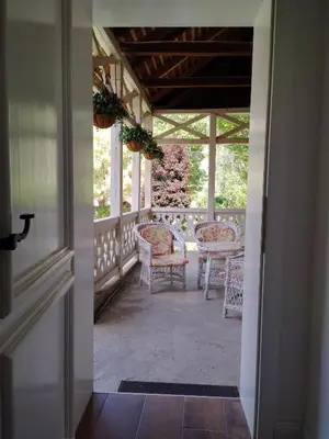 an open door to a porch with chairs and a table at Kuća Petrovića in Aleksandrovac
