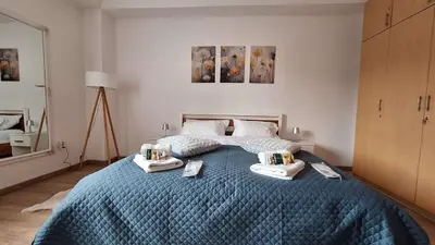 a bedroom with a bed with two towels on it at Apartman Viševac Vranje in Vranje