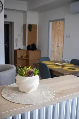 a vase of flowers sitting on top of a table at Apartman Viševac Vranje in Vranje