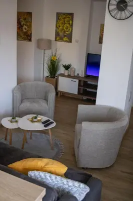 a living room with two chairs and a table at Apartman Viševac Vranje in Vranje