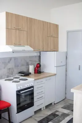 a kitchen with a white stove and a refrigerator at Apartman Viševac Vranje in Vranje