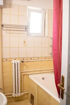 a bathroom with a tub and a window at Apartman Viševac Vranje in Vranje