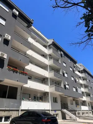 a car parked in front of a building at Apartman Malićanin in Vrnjačka Banja