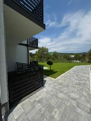 a porch of a house with a view of a field at Apartmani Luna, Borsko jezero in Bor
